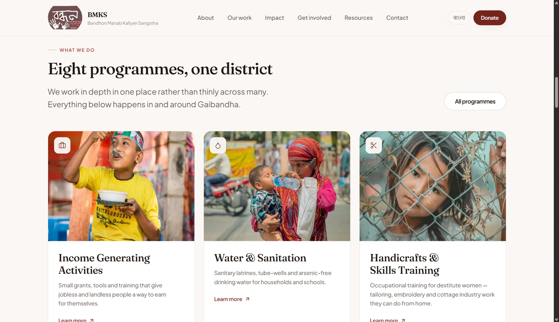 BMKS website programmes section titled 'Eight programmes, one district' showing cards for Income Generating Activities, Water & Sanitation, and Handicrafts & Skills Training
